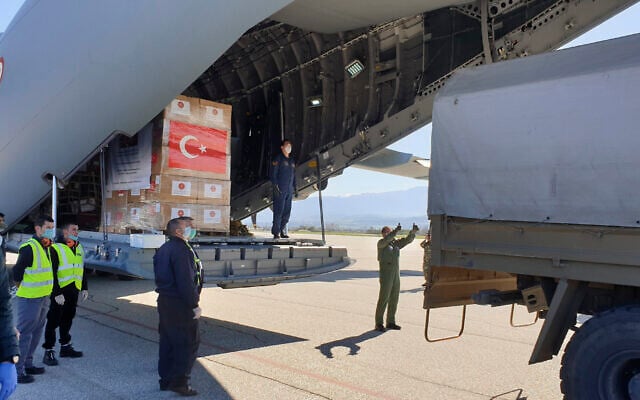 In this handout photo provided by the Turkish Defense Ministry, North Macedonian officials unload Personal Protection Equipment donated by Turkey to help the country combat the coronavirus outbreak, April 8, 2020. (Turkish Defence Ministry via AP) In this handout photo provided by the Turkish Defense Ministry, North Macedonian officials unload Personal Protection Equipment donated by Turkey to help the country combat the coronavirus outbreak, April 8, 2020. (Turkish Defence Ministry via AP)