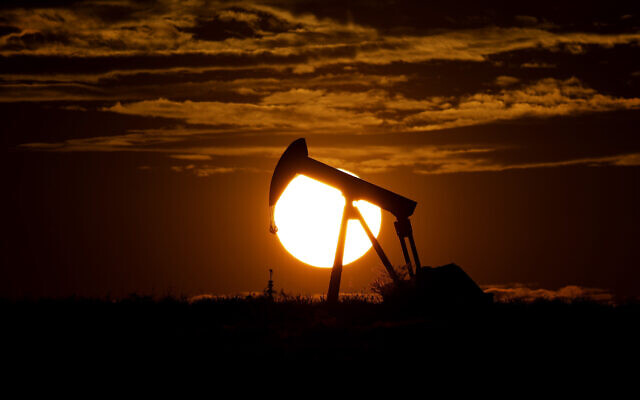 The sun sets behind an idle pump jack near Karnes City, Texas, April 8, 2020 (AP Photo/Eric Gay)