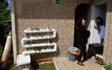 Volunteer Einat Kedem, left, speaks with emergency room doctor Maayan Bacher after delivering her a home-cooked meal, in the Israeli city of Raanana, April 6, 2020 (AP Photo/Sebastian Scheiner)