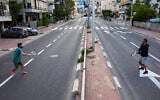 File: Israelis play tennis on an empty road during lockdown following the government's measures to help stop the spread of the coronavirus, in Ramat Gan, near Tel Aviv, April 9, 2020. (AP Photo/Oded Balilty)
