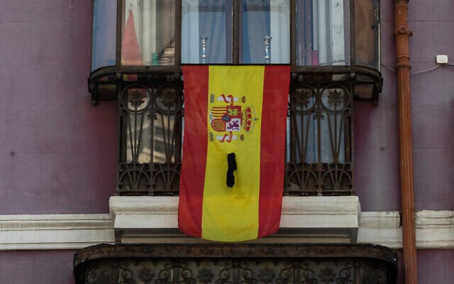 A Spanish flag on a window ledge with a black ribbon in Madrid, April 12, 2020. (AP Photo/Bernat Armangue) A Spanish flag on a window ledge with a black ribbon in Madrid, April 12, 2020. (AP Photo/Bernat Armangue)