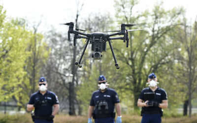 Police officers prepare a drone to find residents who fail to comply with the stay-at-home order implemented due to the coronavirus pandemic in Szolnok, Hungary, April 13, 2020. (Janos Meszaros/MTI via AP)