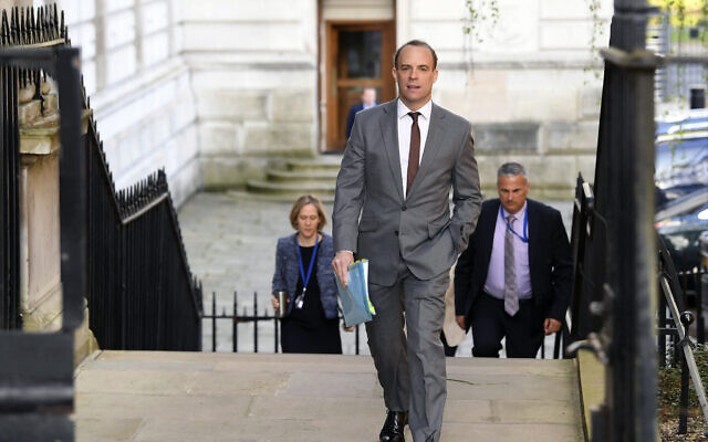 British Foreign Secretary Dominic Raab arrives at Downing Street, London, April 14, 2020 as he stands in for Prime Minister Boris Johnson who is convalescence following his hospitalization with the coronavirus. (Stefan Rousseau / PA via AP) British Foreign Secretary Dominic Raab arrives at Downing Street, London, April 14, 2020 as he stands in for Prime Minister Boris Johnson who is convalescence following his hospitalization with the coronavirus. (Stefan Rousseau / PA via AP)