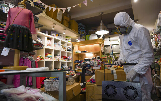 A man in protective gear prepares to sanitize a children's clothes shop to prevent the spread of Covid-19 before it opens, in Rome, April 14, 2020 (AP Photo/Andrew Medichini) A man in protective gear prepares to sanitize a children's clothes shop to prevent the spread of Covid-19 before it opens, in Rome, April 14, 2020 (AP Photo/Andrew Medichini)