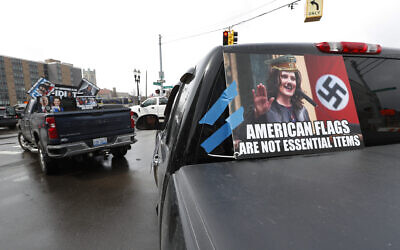 Signs showing Gov. Gretchen Whitmer are taped to vehicles during a protest in Lansing, Michigan, April 15, 2020 (AP/Paul Sancya)