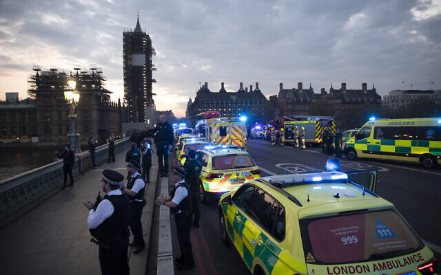 London Ambulance staff, police officers and firefighters take part in the weekly "clap for our carers" as they stand on Westminster Bridge backdropped by a scaffolded Big Ben and the Houses of Parliament in London, during the lockdown to try and stop the spread of the coronavirus, April 16, 2020. (AP Photo/Matt Dunham) London Ambulance staff, police officers and firefighters take part in the weekly "clap for our carers" as they stand on Westminster Bridge backdropped by a scaffolded Big Ben and the Houses of Parliament in London, during the lockdown to try and stop the spread of the coronavirus, April 16, 2020. (AP Photo/Matt Dunham)