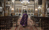 In this April 13, 2020, photo a priest takes part in a Holy Monday ceremony held without worshipers at the Athens Cathedral, in Greece, during a lockdown order by the government to prevent the spread of the coronavirus (AP Photo/Petros Giannakouris)
