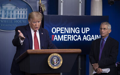 US President Donald Trump speaks about the coronavirus, accompanied by Dr. Anthony Fauci, director of the National Institute of Allergy and Infectious Diseases, in the James Brady Press Briefing Room of the White House, Thursday, April 16, 2020, in Washington. (AP Photo/Alex Brandon)