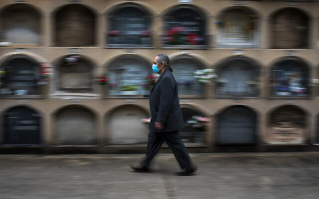 A man arrives at the the Poble Nou cemetery in Barcelona, Spain, April 18, 2020, to attend the funeral of his mother who died of coronavirus. (AP Photo/Emilio Morenatti) A man arrives at the the Poble Nou cemetery in Barcelona, Spain, April 18, 2020, to attend the funeral of his mother who died of coronavirus. (AP Photo/Emilio Morenatti)