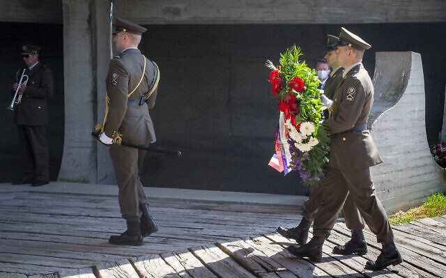 Honor guards carry flowers during a commemoration ceremony for the victims of a World War II camp in Jasenovac, Croatia, April 22, 2020. (AP Photo/Darko Bandic) Honor guards carry flowers during a commemoration ceremony for the victims of a World War II camp in Jasenovac, Croatia, April 22, 2020. (AP Photo/Darko Bandic)