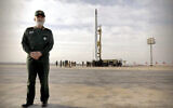 In this photo released April 22, 2020, by Sepahnews, Gen. Amir Ali Hajizadeh, the head of the Revolutionary Guard's aerospace division, stands in front of an Iranian rocket carrying a satellite in an undisclosed site believed to be in Iran's Semnan province. (Sepahnews via AP)