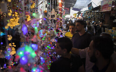 Palestinians shop in the Zawiya market ahead of the Muslim holy month of Ramadan, in Gaza City, April 22, 2020. (AP/Khalil Hamra)