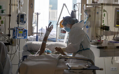 Healthcare workers assist a COVID-19 patient at one of the intensive care units (ICU) of the Ramon y Cajal hospital in Madrid, Spain, on April 24, 2020. (AP Photo/Manu Fernandez)