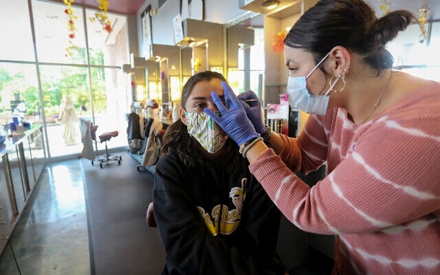 A customer gets her eyebrows waxed at Three-13 Salon, Spa & Boutique on Friday, April 24, 2020, in Marietta, Georgia. The salon had been closed for more than a month due to the new coronavirus. (AP Photo/Ron Harris) A customer gets her eyebrows waxed at Three-13 Salon, Spa & Boutique on Friday, April 24, 2020, in Marietta, Georgia. The salon had been closed for more than a month due to the new coronavirus. (AP Photo/Ron Harris)