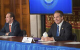 New York Governor Andrew Cuomo addresses the media while holding an N95 mask during his daily press briefing on COVID-19, at the state capitol in Albany, New York, April 24, 2020. (Darren McGee/Office of Governor Andrew M. Cuomo via AP)