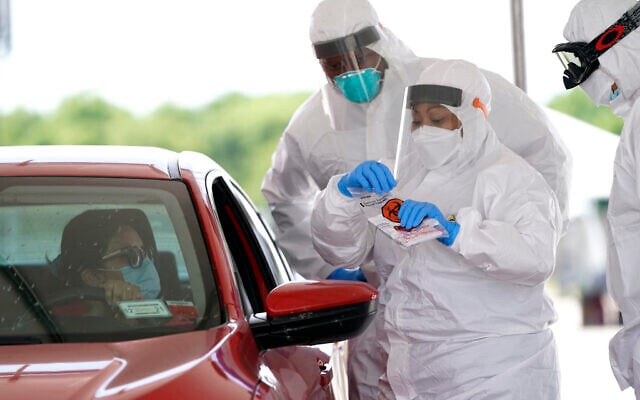 Registered nurse April Lewis, center, prepares to administer a test at a newly opened United Memorial Medical Center COVID-19 drive-thru testing site, April 27, 2020, in Houston. (AP/David J. Phillip) Registered nurse April Lewis, center, prepares to administer a test at a newly opened United Memorial Medical Center COVID-19 drive-thru testing site, April 27, 2020, in Houston. (AP/David J. Phillip)