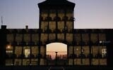 Virtual memorial plaques are projected on the gates of Auschwitz-Birkenau for Holocaust Remembrance Day, April 20, 2020. (Marcin Kozlowski/March of the Living)