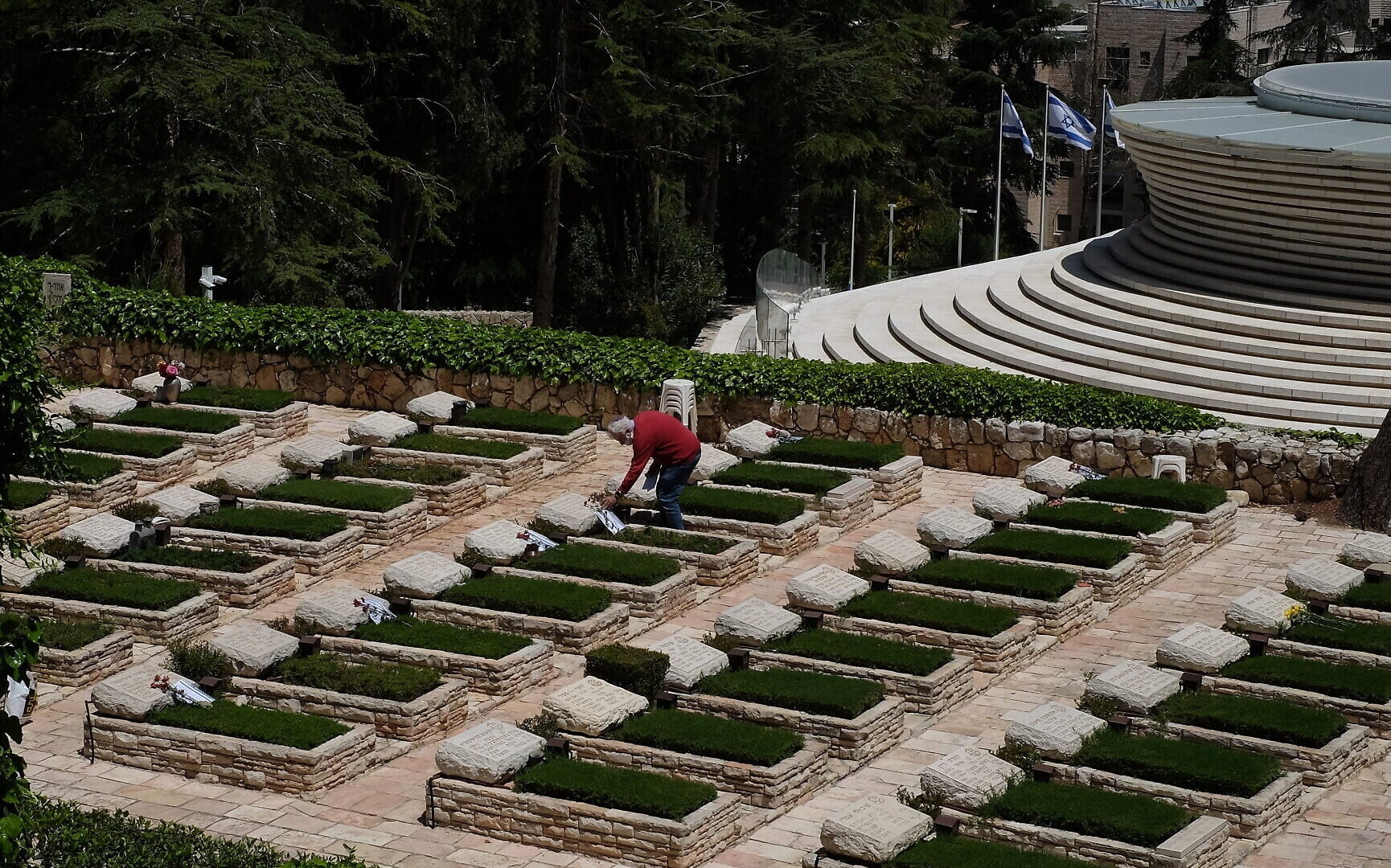 Chaim Frenkel puts a flower and a note on a grave on Mount Herzl in Jerusalem ahead of next week's Memorial Day, on April 23, 2020. (Judah Ari Gross/Times of Israel) Chaim Frenkel puts a flower and a note on a grave on Mount Herzl in Jerusalem ahead of next week's Memorial Day, on April 23, 2020. (Judah Ari Gross/Times of Israel)