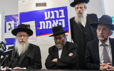 Health Ministe Yaakov Litzman (left) at an election campaign opening event for his United Torah Judaism party in Bnei Brak on May 30, 2019. The party slogan on the banner behind him reads 'At the moment of truth.' (Flash90)