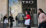 File: People walk past black friday advertisements at an outlet of the "Castro" fashion chain in Jerusalem, November 24, 2019 (Olivier Fitoussi/Flash90)