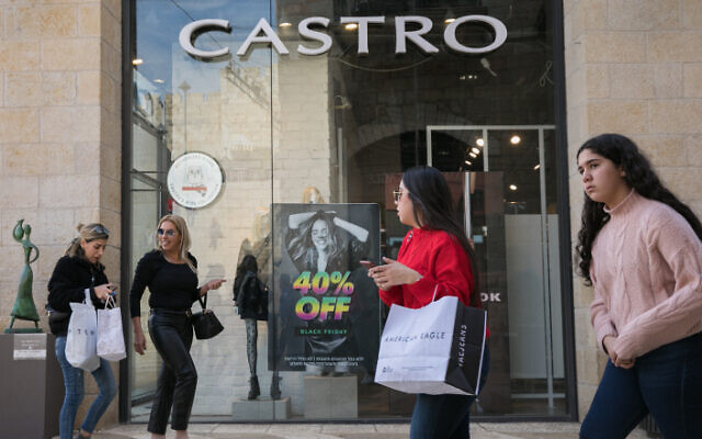 File: People walk past black friday advertisements at an outlet of the "Castro" fashion chain in Jerusalem, November 24, 2019 (Olivier Fitoussi/Flash90) File: People walk past black friday advertisements at an outlet of the "Castro" fashion chain in Jerusalem, November 24, 2019 (Olivier Fitoussi/Flash90)
