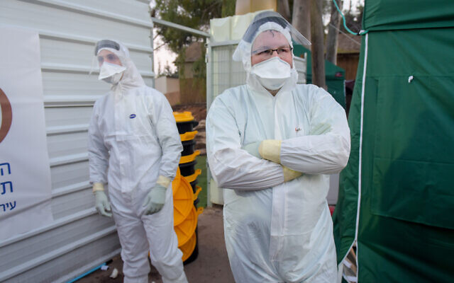 Workers outside a building at Sheba Medical Center which was converted to a coronavirus department, February 20, 2020. (Avshalom Sassoni/Flash90) Workers outside a building at Sheba Medical Center which was converted to a coronavirus department, February 20, 2020. (Avshalom Sassoni/Flash90)