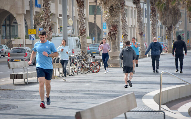 People run near the beach in Tel Aviv on March 19, 2020 (Avshalom Sassoni/Flash90) People run near the beach in Tel Aviv on March 19, 2020 (Avshalom Sassoni/Flash90)