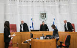 Supreme Court Chief Justice Esther Hayut, center, arrives with fellow justices at a court hearing on Prime Minister Benjamin Netanyahu's decision to authorize Israel’s Shin Bet security agency to use cellphone location data to track coronavirus carriers, March 19, 2019. (Olivier Fitoussi/Flash90)
