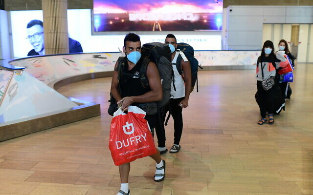 Illustrative: Israeli travelers who had been stranded in South America, arrive at Ben Gurion airport on March 23, 2020, from Sao Paulo via New York. (Tomer Neuberg/Flash90) Illustrative: Israeli travelers who had been stranded in South America, arrive at Ben Gurion airport on March 23, 2020, from Sao Paulo via New York. (Tomer Neuberg/Flash90)