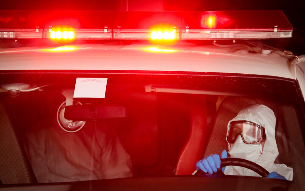 Magen David Adom workers wearing protective clothing as a preventive measure evacuating a man suspected of having coronavirus to Shaarei Tsedek hospital in Jerusalem, March 30, 2020. (Yossi Zamir/Flash90)
