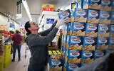 A woman shops for matzah at a supermarket in Jerusalem on March 31, 2020. (Yossi Zamir/Flash90/File)
