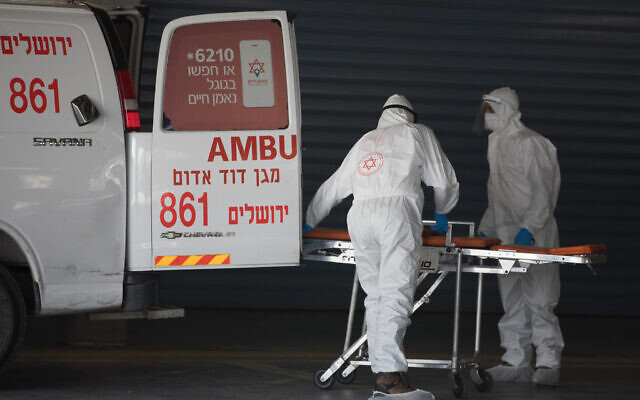 Magen David Adom workers wearing protective clothing evacuate a suspected coronavirus patient outside the new coronavirus unit at Shaare Zedek hospital in Jerusalem, April 3, 2020. (Nati Shohat/ Flash90) Magen David Adom workers wearing protective clothing evacuate a suspected coronavirus patient outside the new coronavirus unit at Shaare Zedek hospital in Jerusalem, April 3, 2020. (Nati Shohat/ Flash90)