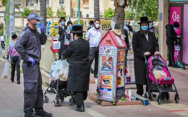 Ultra-Orthodox Jews standing in line outside a supermarket in the central Israeli city of Elad, on April 7, 2020. (Yossi Aloni/Flash90) Ultra-Orthodox Jews standing in line outside a supermarket in the central Israeli city of Elad, on April 7, 2020. (Yossi Aloni/Flash90)