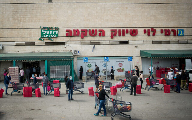 People waiting in line outside Rami Levy supermarket in Jerusalem on April 7, 2020. (Yonatan Sindel/Flash90) People waiting in line outside Rami Levy supermarket in Jerusalem on April 7, 2020. (Yonatan Sindel/Flash90)