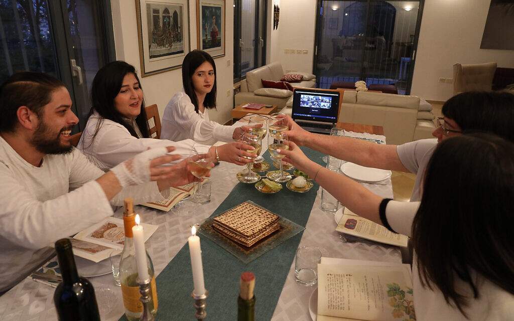 An Israeli family celebrates the Passover Seder with family through a video chatting app on the first night of the Jewish holiday in Tzur Hadassah on April 8, 2020. (Nati Shohat/Flash90) An Israeli family celebrates the Passover Seder with family through a video chatting app on the first night of the Jewish holiday in Tzur Hadassah on April 8, 2020. (Nati Shohat/Flash90)