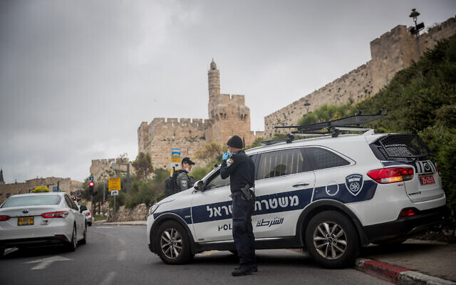 Israeli Police officers at a temporary "checkpoint" near the Old City Walls in Jerusalem on April 10, 2020, to check if people are not disobeying the governments orders on a partial lockdown, in order to prevent the spread of the Coronavirus. (Yonatan Sindel/Flash90)