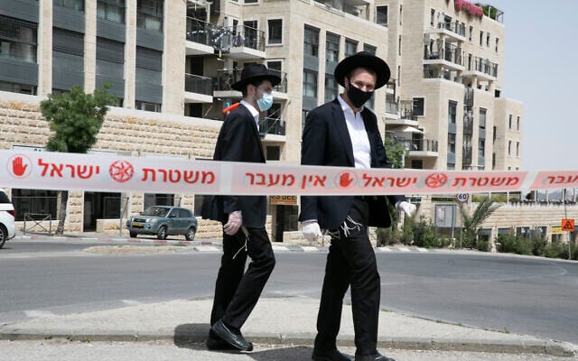 People cross a police roadblock in an ultra-Orthodox neighborhood of Jerusalem on April 19, 2020. (Olivier Fitoussi/Flash90) People cross a police roadblock in an ultra-Orthodox neighborhood of Jerusalem on April 19, 2020. (Olivier Fitoussi/Flash90)