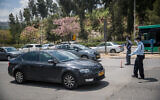 Police officers at a temporary checkpoint at the entrance to the Ramot neighborhood in Jerusalem, April 12, 2020. (Yonatan Sindel/Flash90)