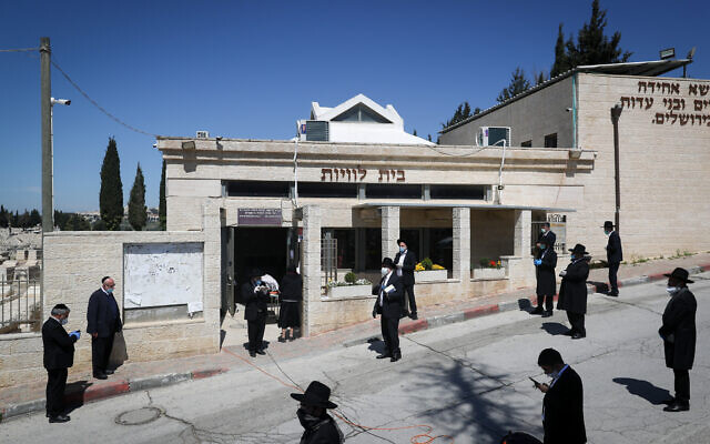 The funeral of Rabbi Eliyahu Bakshi-Doron, who died from complications of COVID-19, at the Har Hamenuhot cemetery in Jerusalem, April 13, 2020. (Yonatan Sindel/Flash90) The funeral of Rabbi Eliyahu Bakshi-Doron, who died from complications of COVID-19, at the Har Hamenuhot cemetery in Jerusalem, April 13, 2020. (Yonatan Sindel/Flash90)