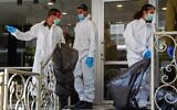 IDF Home Front Command soldiers in protective gear at a nursing home in Bnei Brak on April 14, 2020. (Flash90)