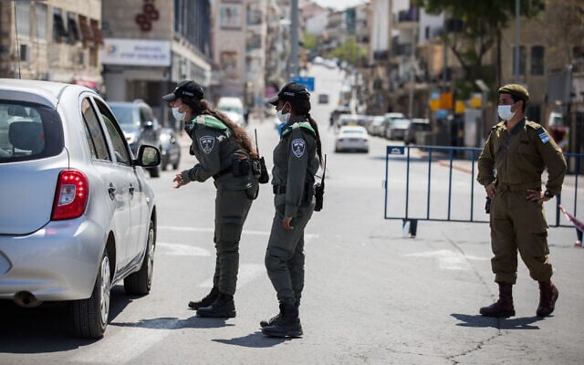 Illustrative: Border Police officers and an IDF soldier at a temporary checkpoint in Jerusalem on April 14, 2020, ahead of the start of a nationwide closure for the Passover holiday. (Nati Shohat/Flash90) Illustrative: Border Police officers and an IDF soldier at a temporary checkpoint in Jerusalem on April 14, 2020, ahead of the start of a nationwide closure for the Passover holiday. (Nati Shohat/Flash90)