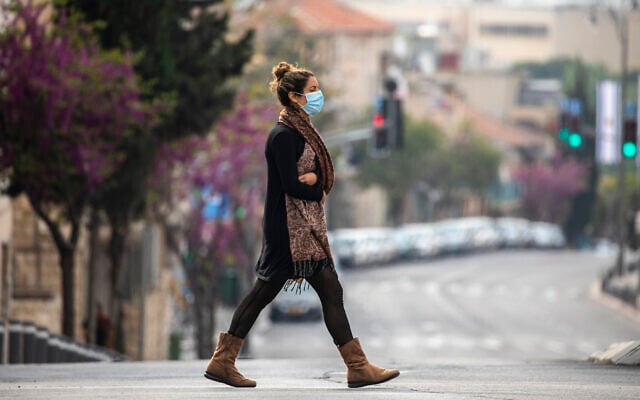 An Israeli woman with a face mask walks in Jerusalem on April 15, 2020. (Olivier Fitoussi/Flash90)