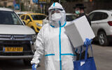 A Magen David Adom ambulance service medic handling coronavirus tests in Jerusalem on April 19, 2020. (Nati Shohat/Flash90)