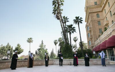 Spiritual leaders of all faiths in Israel: Sephardi Chief Rabbi Yitzhak Yosef, Ashkenazi Chief Rabbi David Lau,  Greek Orthodox Patriarch of Jerusalem Theophilos III, the Latin Patriarch Archbishop Pierbattista Pizzaballa, Imam Sheikh Gamal el Ubra, Imam Sheikh Agel Al-Atrash and Druze Spiritual leader Sheikh Mowafaq Tarif attend a united prayer at the King David Hotel in Jerusalem on April 22, 2020.(Olivier Fitoussi/Flash90)