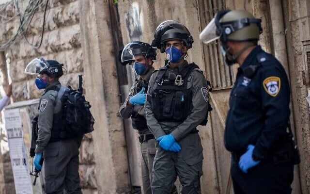 Police officers during a raid in the ultra-orthodox Jewish neighborhood of Mea Shearim on April 22, 2020. (Yonatan Sindel/Flash90) Police officers during a raid in the ultra-orthodox Jewish neighborhood of Mea Shearim on April 22, 2020. (Yonatan Sindel/Flash90)