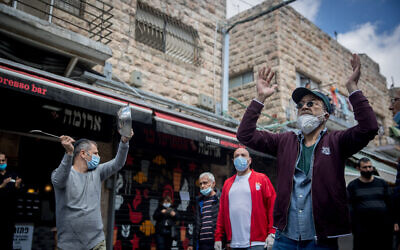 Stall-owners at Jerusalem's Mahane Yehuda market protest the ongoing closure of their businesses, amid the coronavirus crisis, April 26, 2020. (Yonatan Sindel/Flash90)