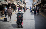 Shoppers at the Mahane Yehuda market in Jerusalem on April 25, 2020. (Yonatan Sindel/Flash90)