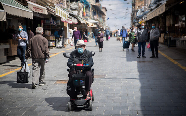 Shoppers at the Mahane Yehuda market in Jerusalem on April 25, 2020. (Yonatan Sindel/Flash90) Shoppers at the Mahane Yehuda market in Jerusalem on April 25, 2020. (Yonatan Sindel/Flash90)