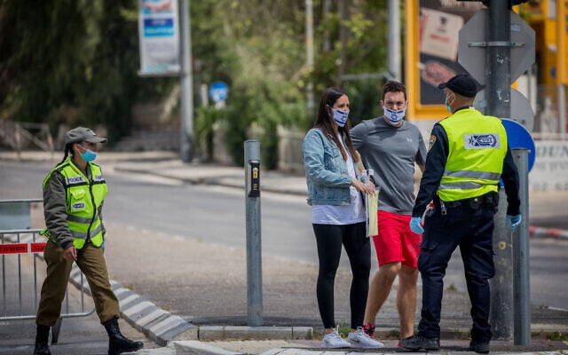 Israeli police guard a roadblock in Jerusalem, on April 29, 2020, as Israel celebrates its 72th Independence Day under lockdown due to the coronavirus. (Yonatan Sindel/Flash90) Israeli police guard a roadblock in Jerusalem, on April 29, 2020, as Israel celebrates its 72th Independence Day under lockdown due to the coronavirus. (Yonatan Sindel/Flash90)