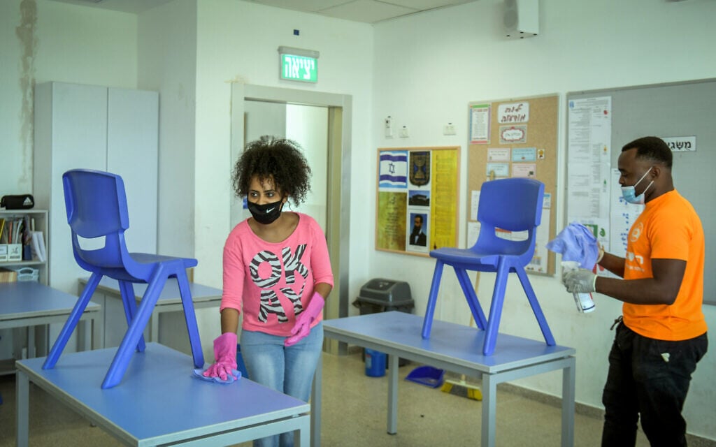 Workers clean a classroom at Luba Eliav primary school in Rishon Lezion on April 30, 2020. (Flash90)